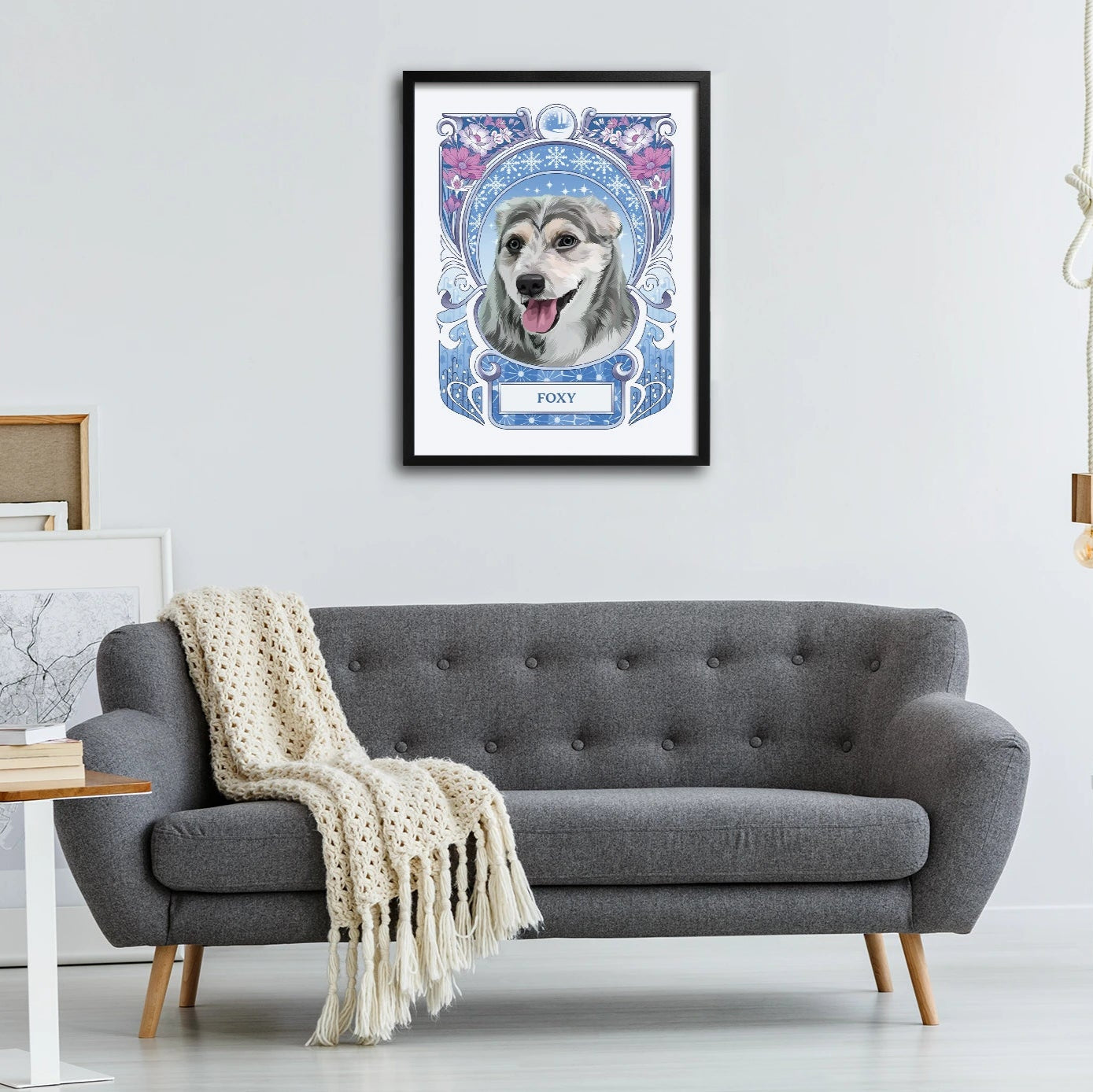 Framed picture of a dog on a wall above a gray sofa in a living room.