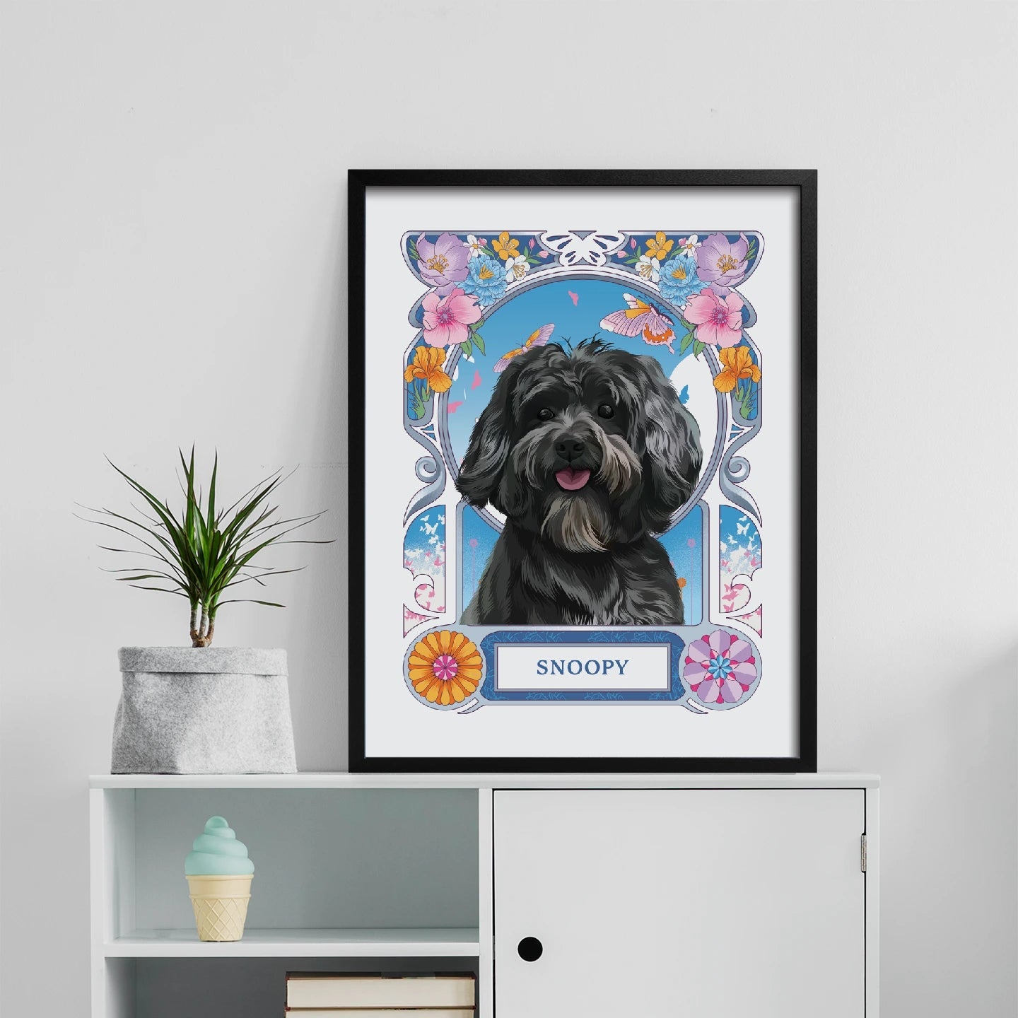 Framed portrait of a dog named Snoopy on a white shelf with decorative items.
