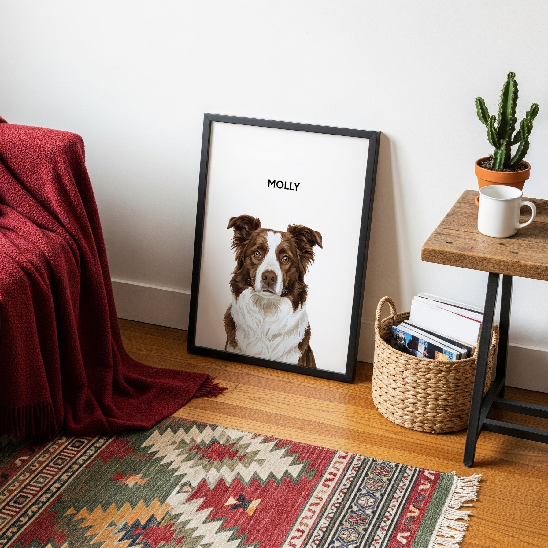 Living room with a framed picture of a dog named Molly, a red blanket, and a small table with a plant and mug.